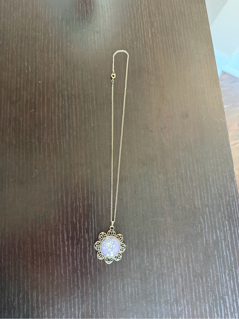 Silver-tone pendant necklace featuring a snowflake design.